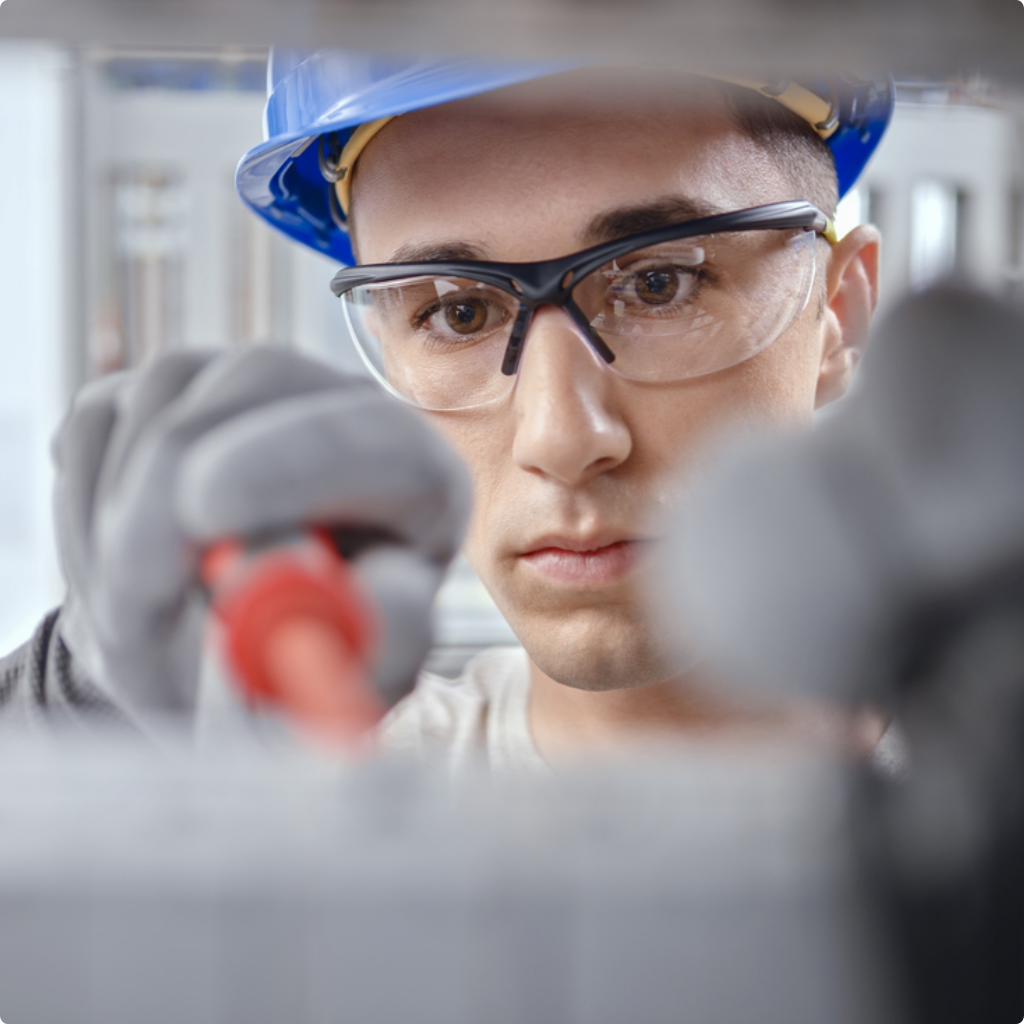 Electrician working on control panel at construction site